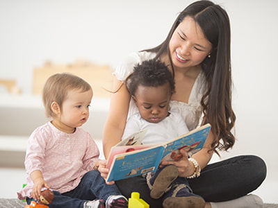 Image of woman reading to children